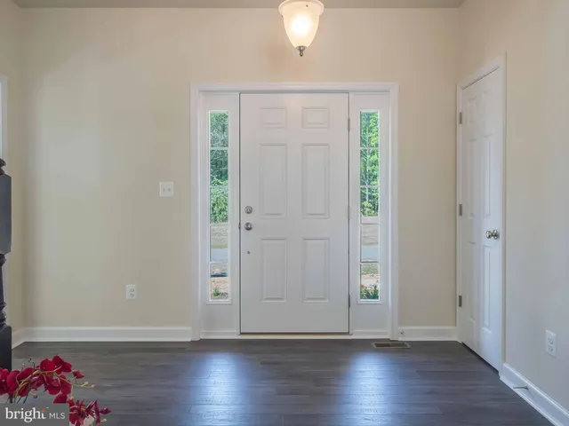 an empty room with wooden floor and closet