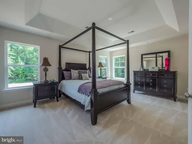 a bedroom with a bed table and window