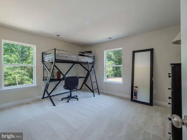 a view of a room with gym equipment and windows