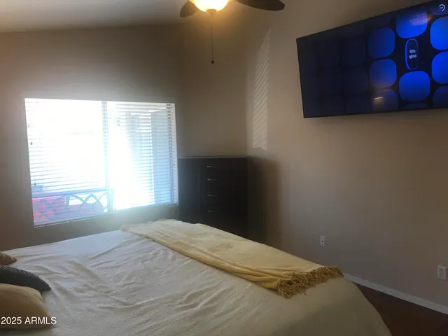 a bedroom with a bed and a window