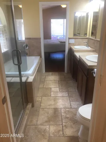 a bathroom with a sink a toilet and mirror