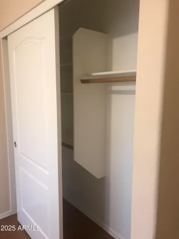 a view of walk in closet with empty racks