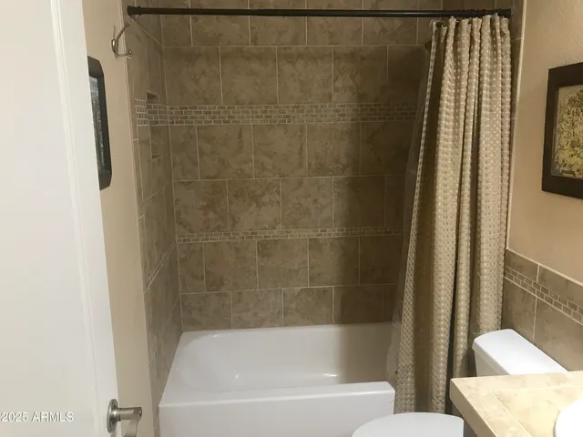 a bathroom with a bathtub and shower
