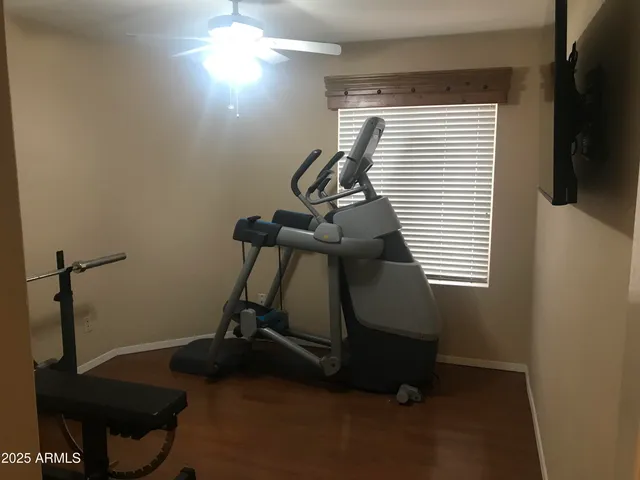 a room with gym equipment and windows