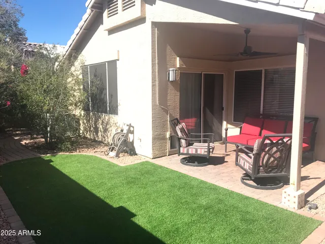 a view of a backyard with sitting area