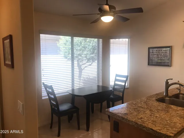 a view of a room that has a table and chairs in it
