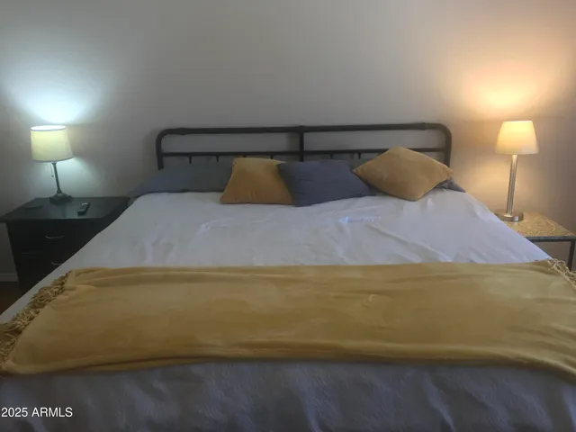 a bedroom with a bed and a lamp