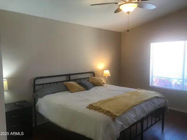 a bedroom with a bed and a chandelier