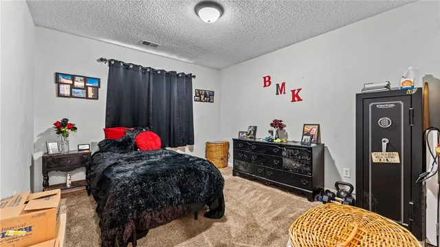 a bed room with a bed and a dresser