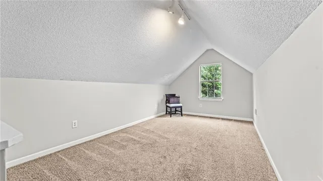 an empty room with windows and mirror