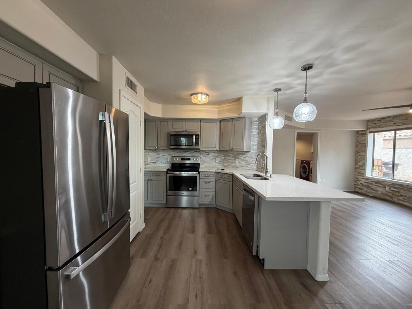902 South Surfside Drive Gilbert, AZ 85233 - Photo 11 of 35 a large kitchen with stainless steel appliances a refrigerator and a stove top oven