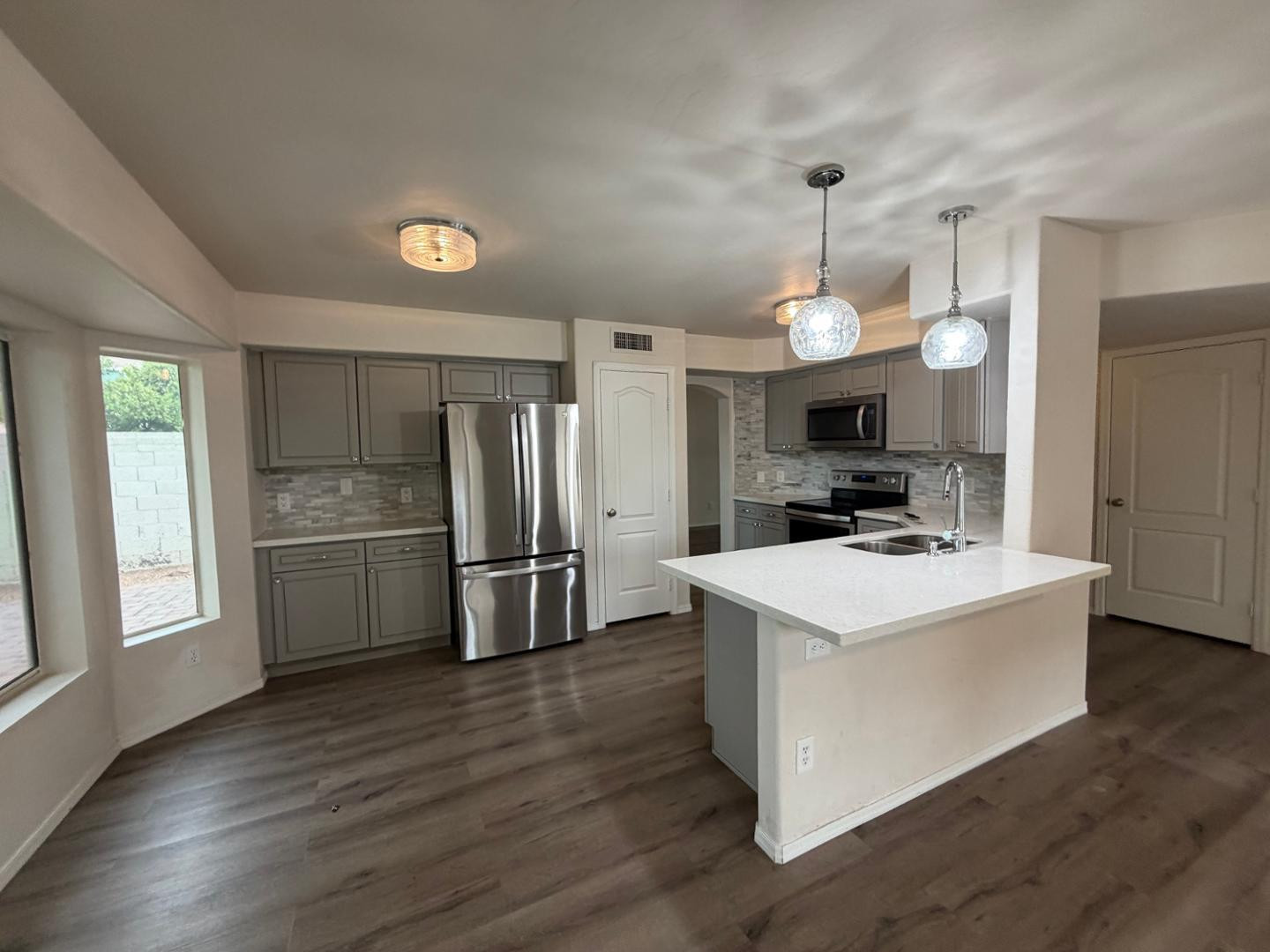 902 South Surfside Drive Gilbert, AZ 85233 - Photo 14 of 35 a kitchen that has a sink a stove a refrigerator and a window