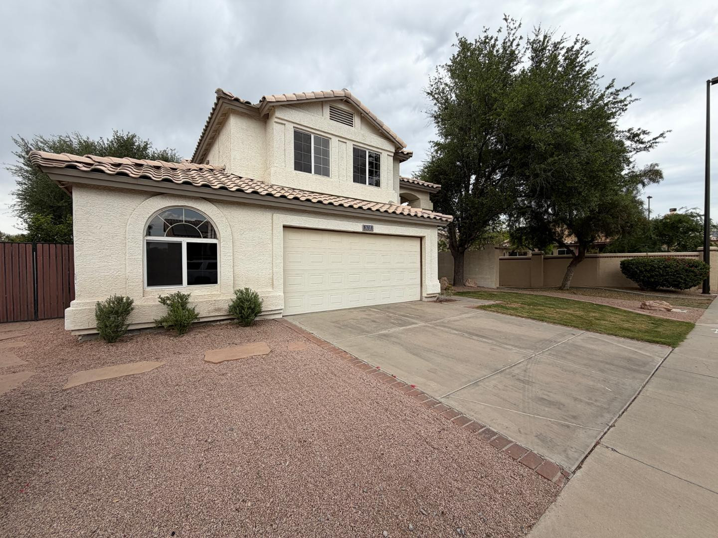 902 South Surfside Drive Gilbert, AZ 85233 - Photo 2 of 35 a front view of a house with a yard and garage