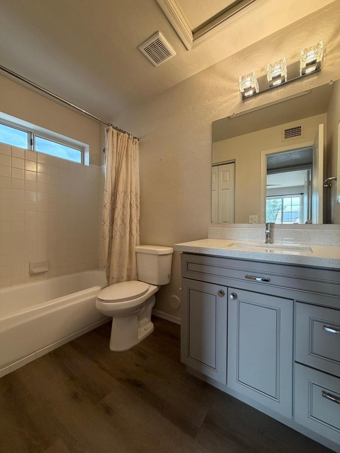 902 South Surfside Drive Gilbert, AZ 85233 - Photo 24 of 35 a bathroom with a granite countertop toilet a sink and a mirror