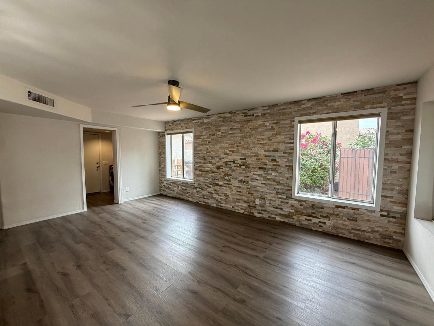 902 South Surfside Drive Gilbert, AZ 85233 - Photo 9 of 35 an empty room with wooden floor and windows