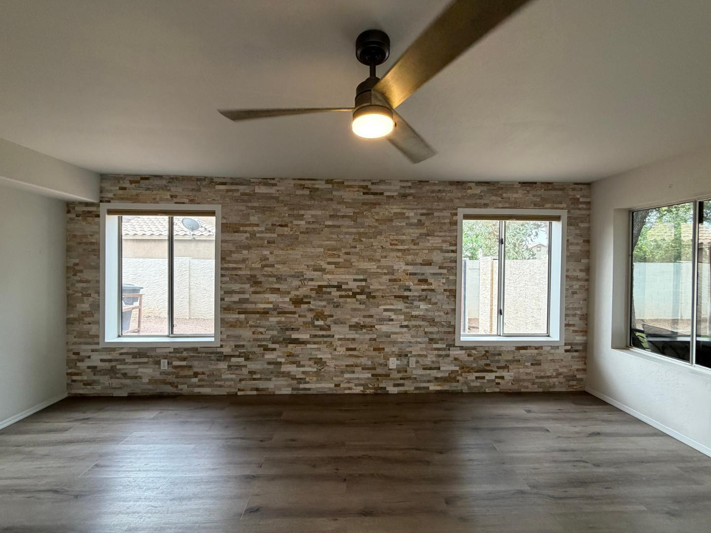 902 South Surfside Drive Gilbert, AZ 85233 - Photo 10 of 35 an empty room with wooden floor and windows