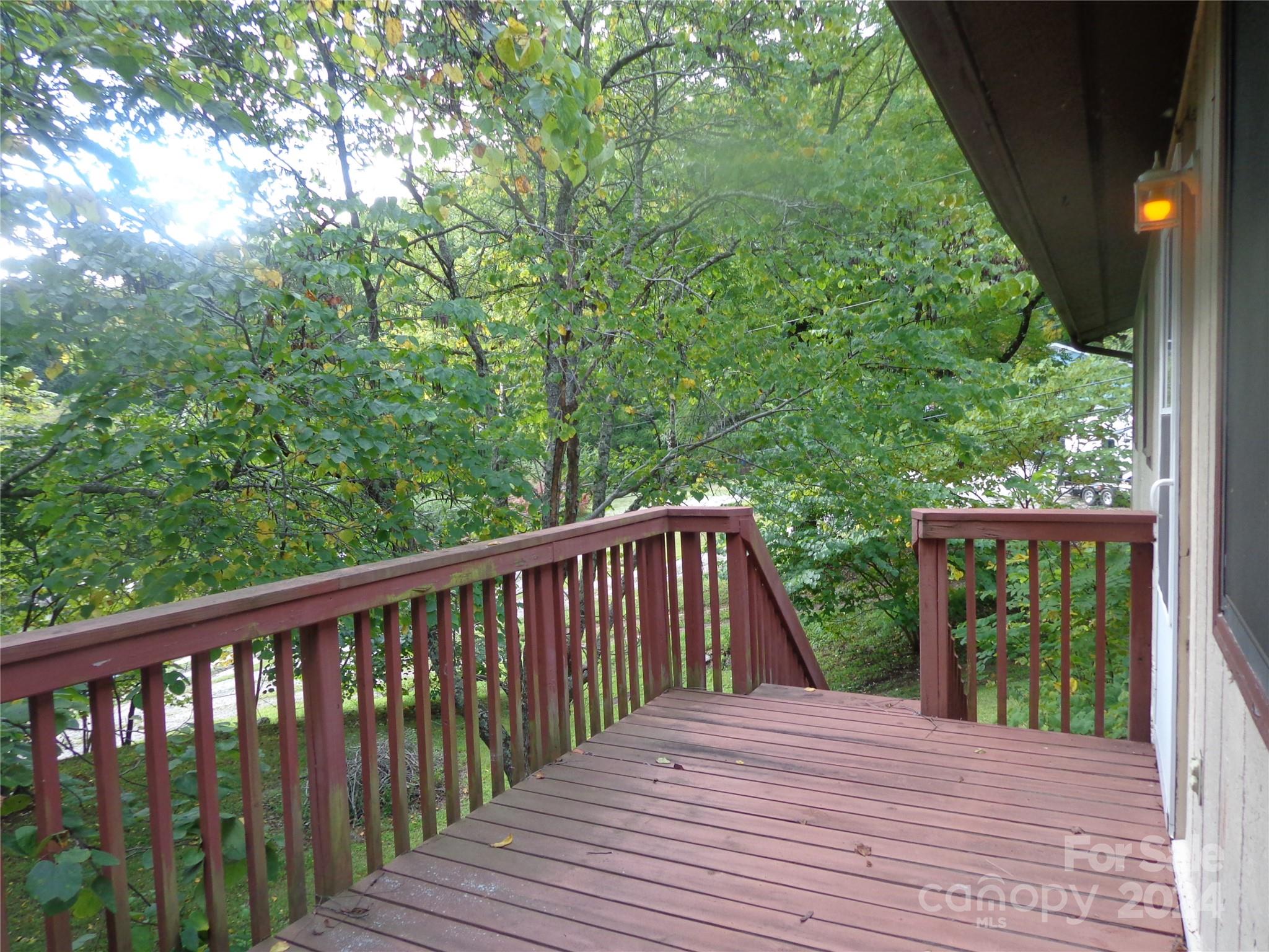 981 Rufus Robinson Road Sylva, NC 28779 - Photo 17 of 27 a balcony with wooden floor and yard in the back