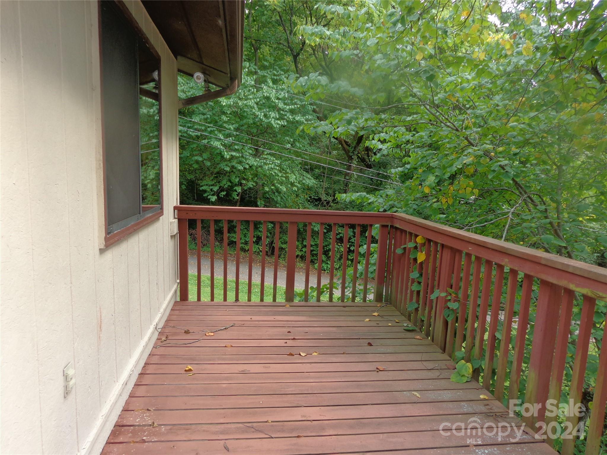 981 Rufus Robinson Road Sylva, NC 28779 - Photo 18 of 27 a balcony with wooden floor and fence