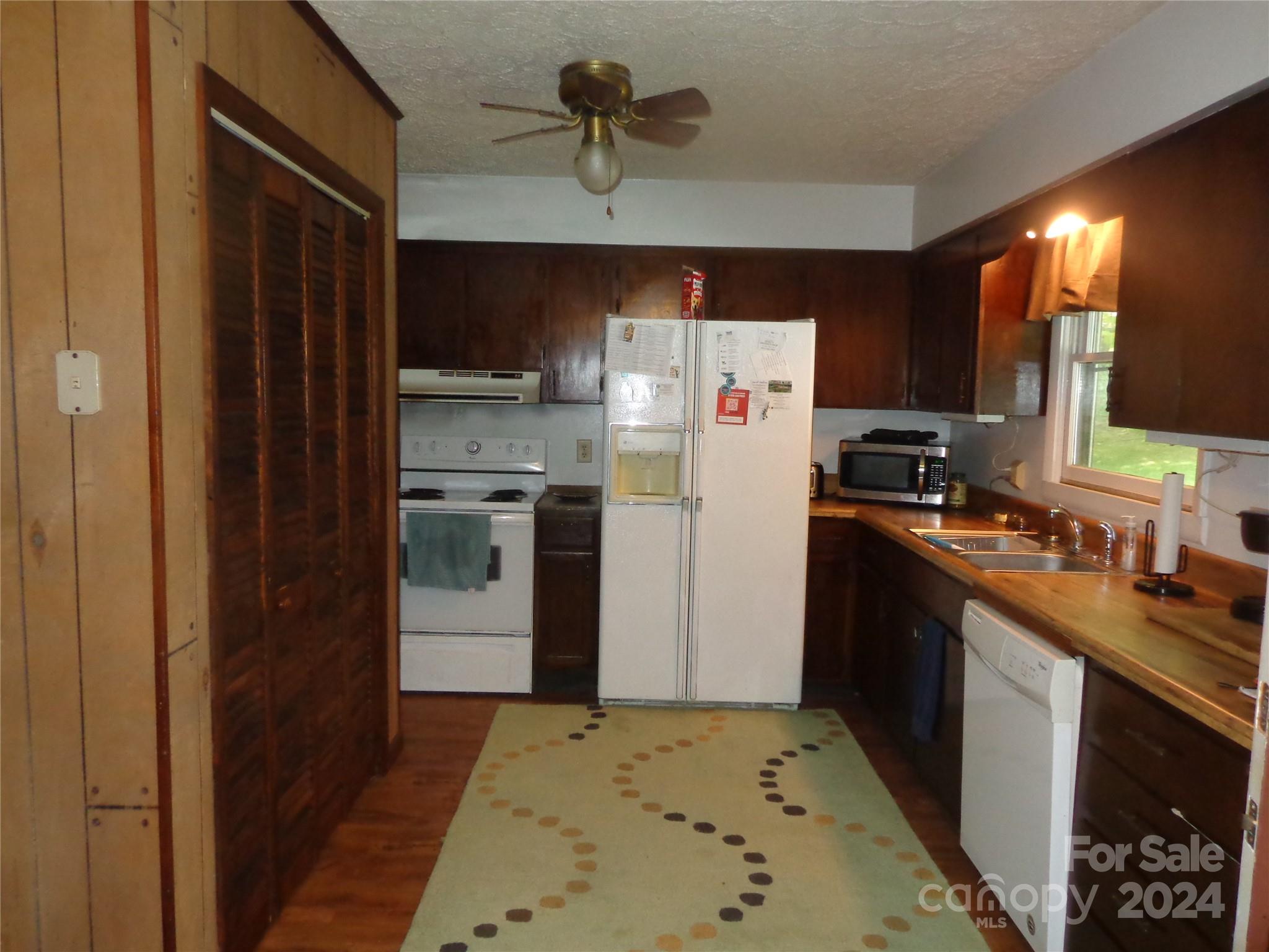 981 Rufus Robinson Road Sylva, NC 28779 - Photo 2 of 27 a kitchen with stainless steel appliances granite countertop a refrigerator and a sink