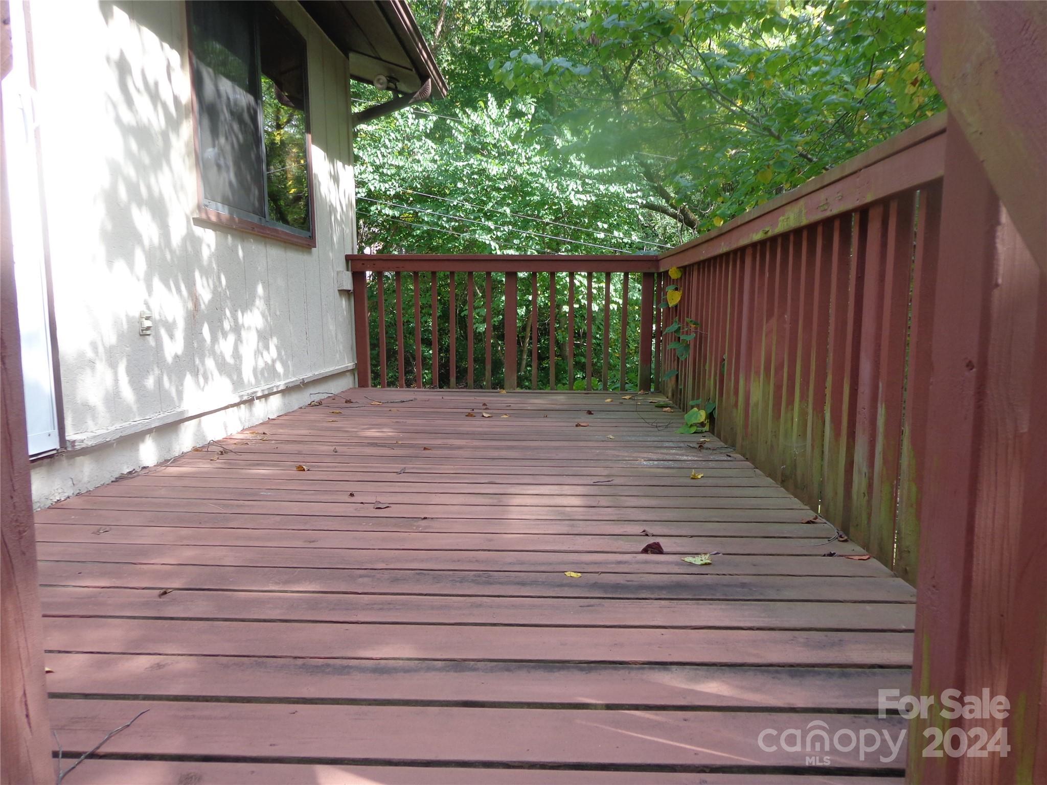 981 Rufus Robinson Road Sylva, NC 28779 - Photo 23 of 27 a view of backyard with wooden fence and trees