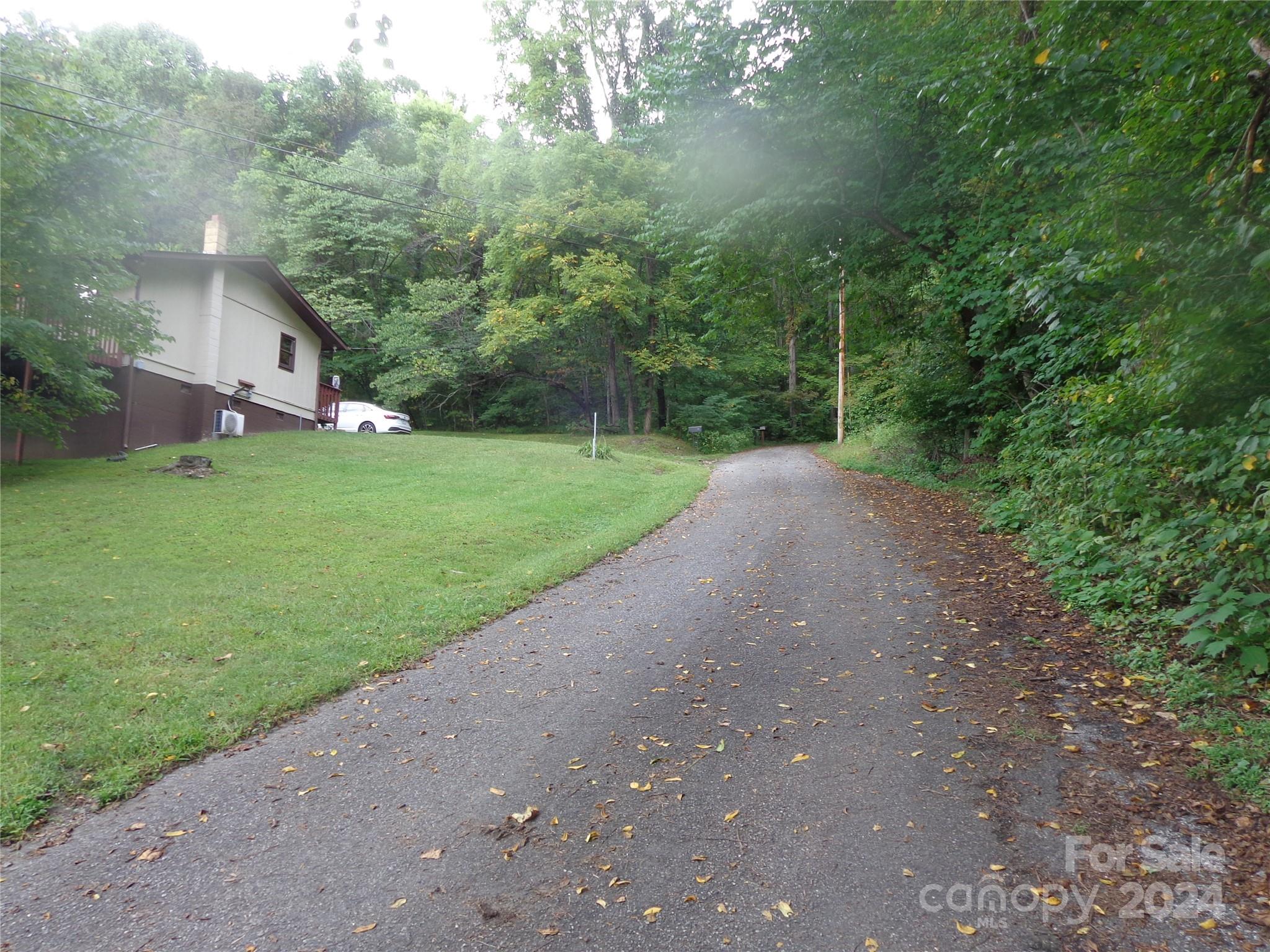 981 Rufus Robinson Road Sylva, NC 28779 - Photo 27 of 27 a view of a yard with a house and a street