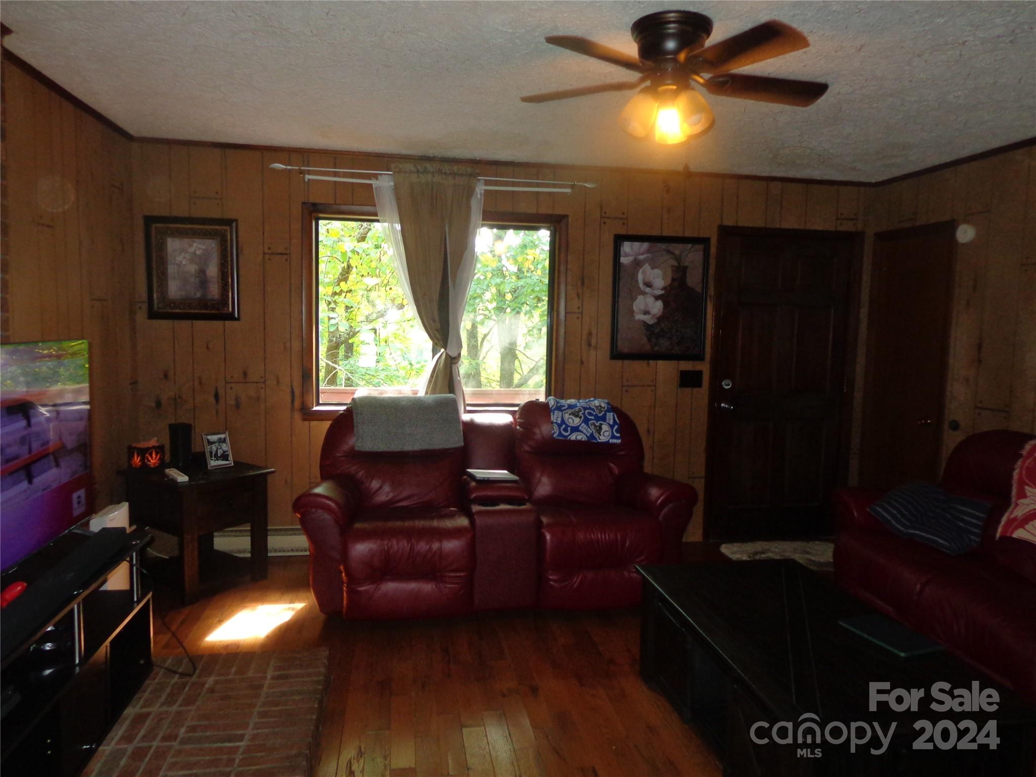 981 Rufus Robinson Road Sylva, NC 28779 - Photo 4 of 27 a living room with furniture and a chandelier