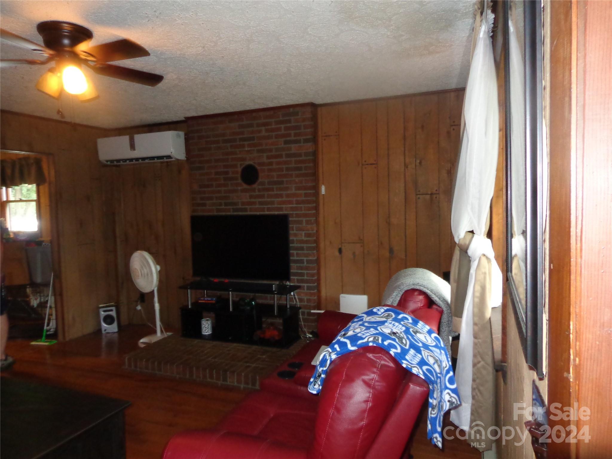 981 Rufus Robinson Road Sylva, NC 28779 - Photo 5 of 27 a bedroom with a bed and a chandelier