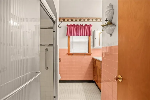 a bathroom with a shower and a sink