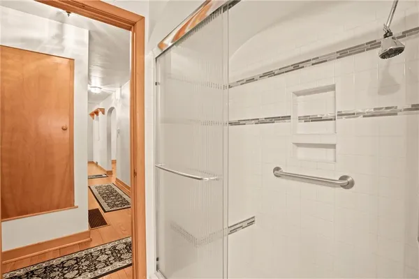 a bathroom with a shower and a glass door