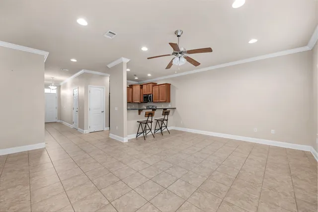 a view of a livingroom with furniture and a ceiling fan