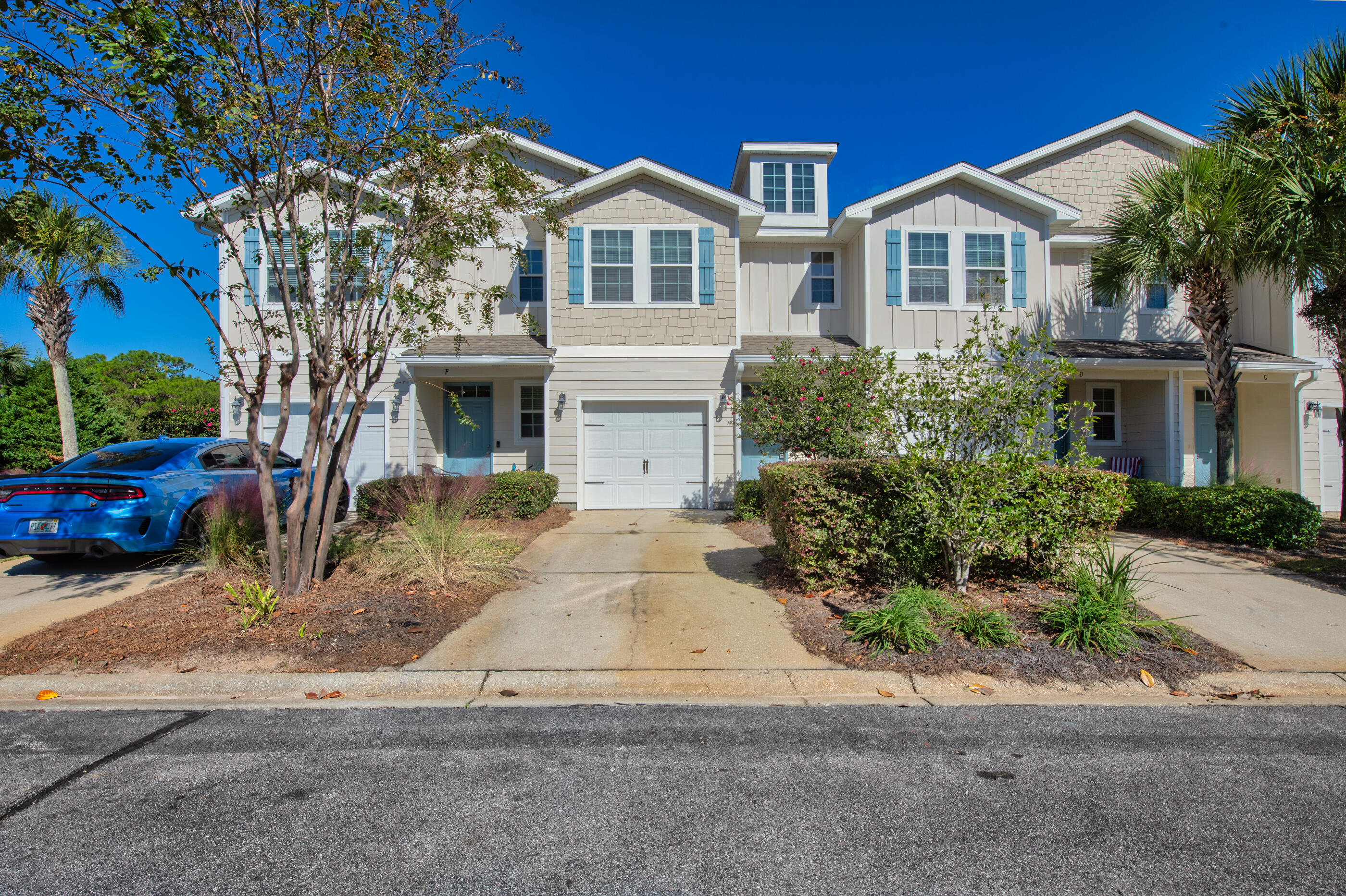 19 East Shady Oaks Lane, Unit E Santa Rosa Beach, FL 32459 - Photo 2 of 33 a front view of a house with a yard and garage