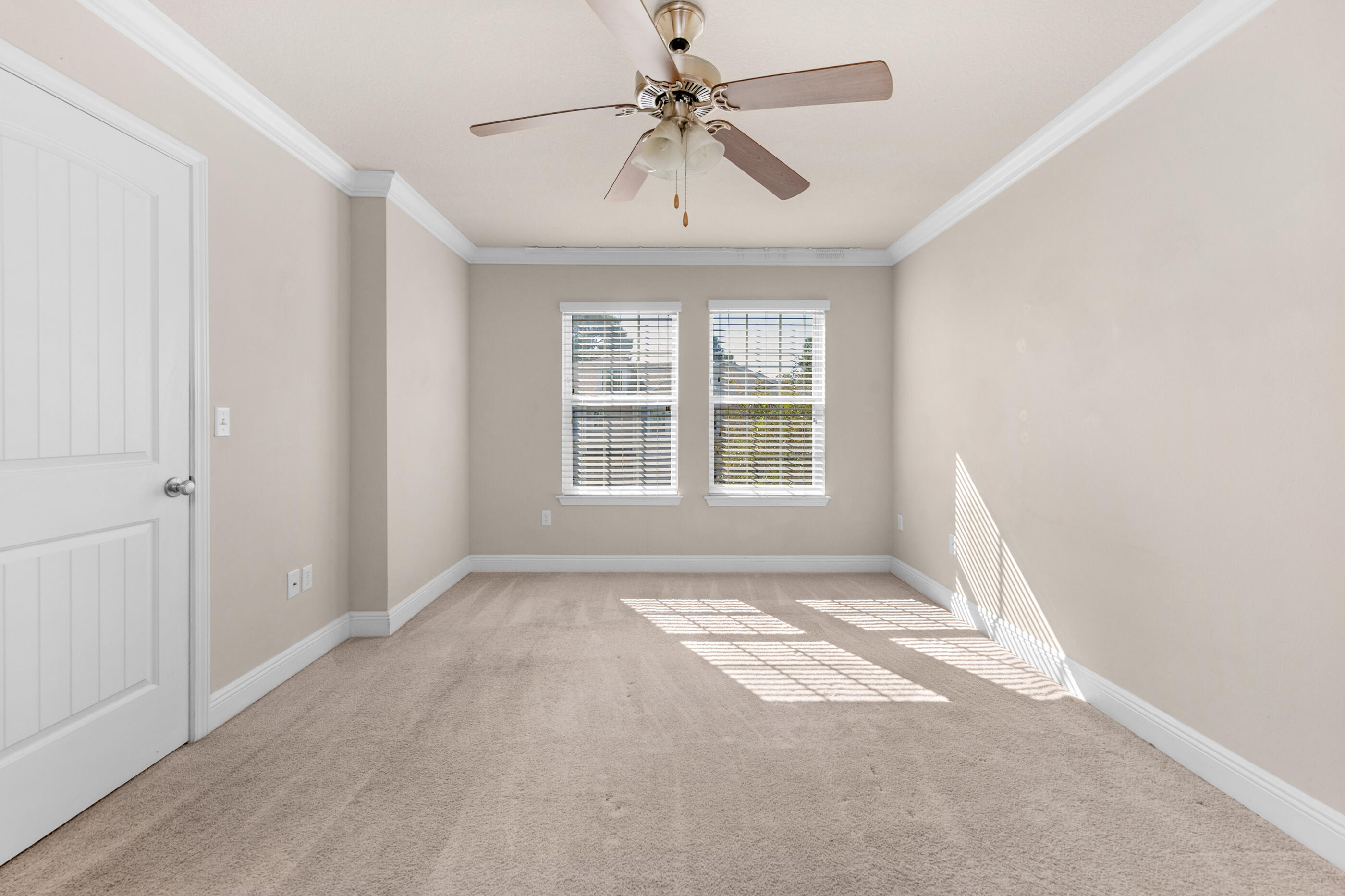 19 East Shady Oaks Lane, Unit E Santa Rosa Beach, FL 32459 - Photo 22 of 33 an empty room with windows and fan