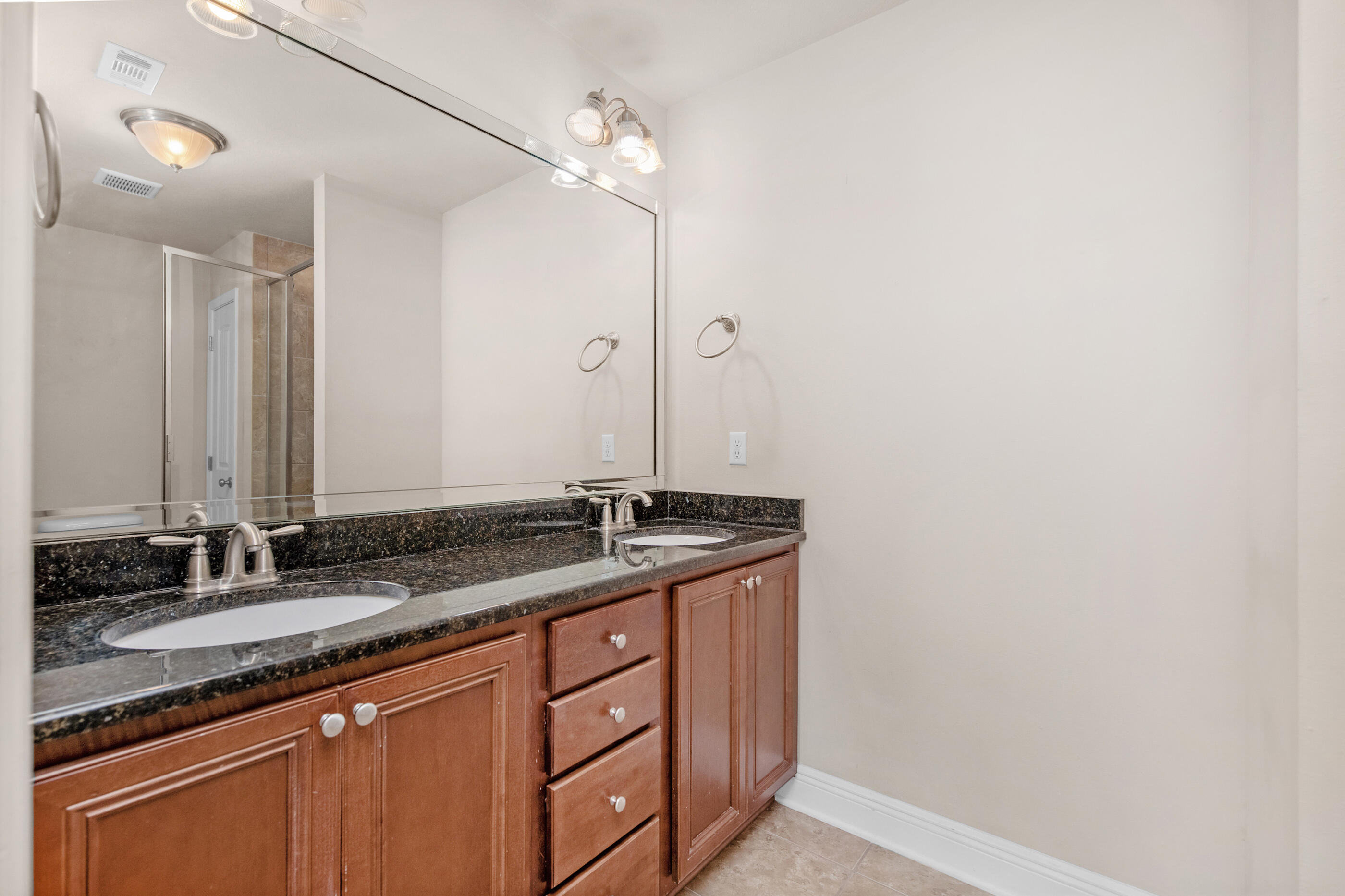 19 East Shady Oaks Lane, Unit E Santa Rosa Beach, FL 32459 - Photo 25 of 33 a bathroom with a granite countertop sink and a mirror