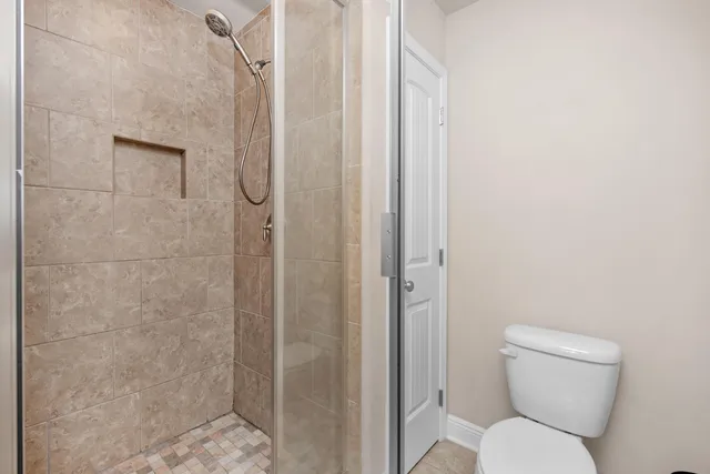 a bathroom with a toilet and a shower