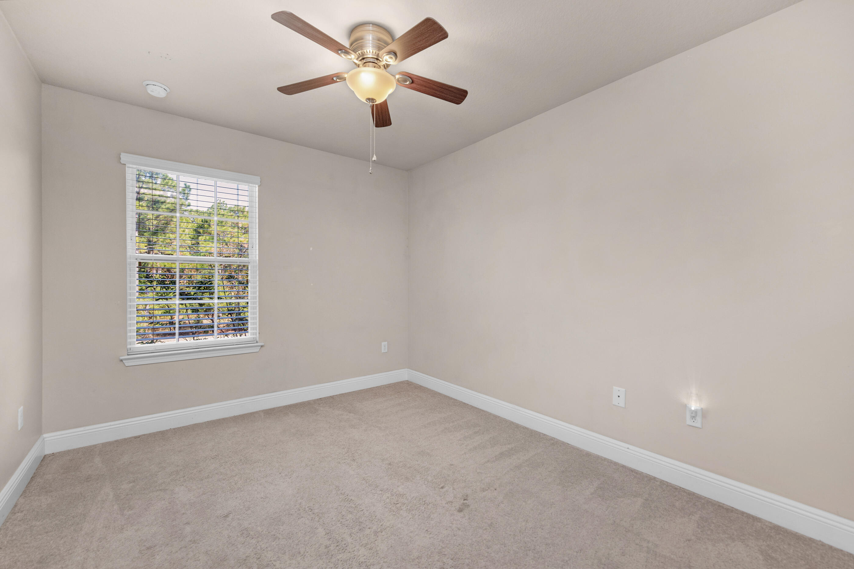 19 East Shady Oaks Lane, Unit E Santa Rosa Beach, FL 32459 - Photo 27 of 33 an empty room with a window and a fan