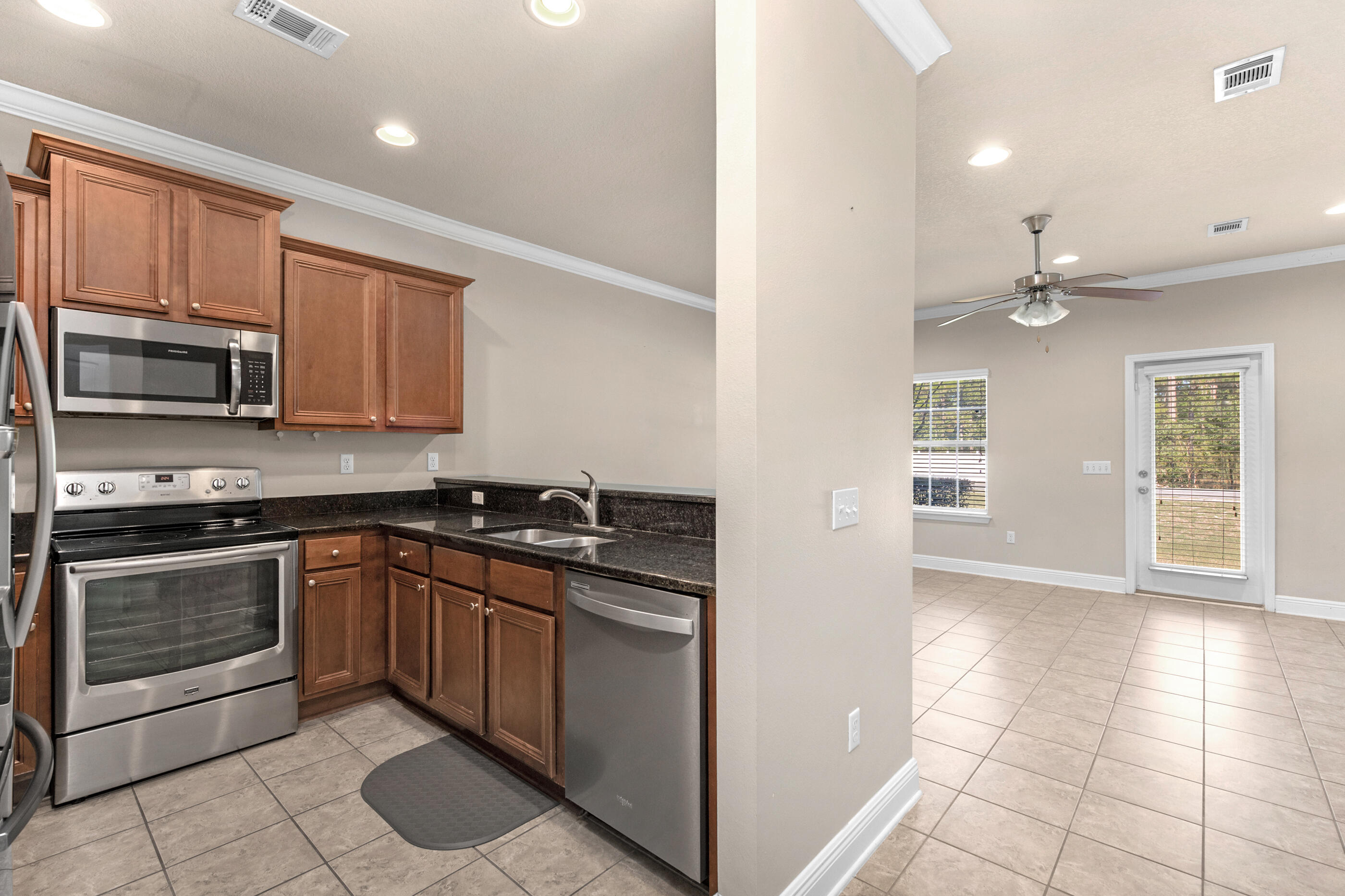 19 East Shady Oaks Lane, Unit E Santa Rosa Beach, FL 32459 - Photo 7 of 33 a kitchen with stainless steel appliances granite countertop a stove top oven and sink