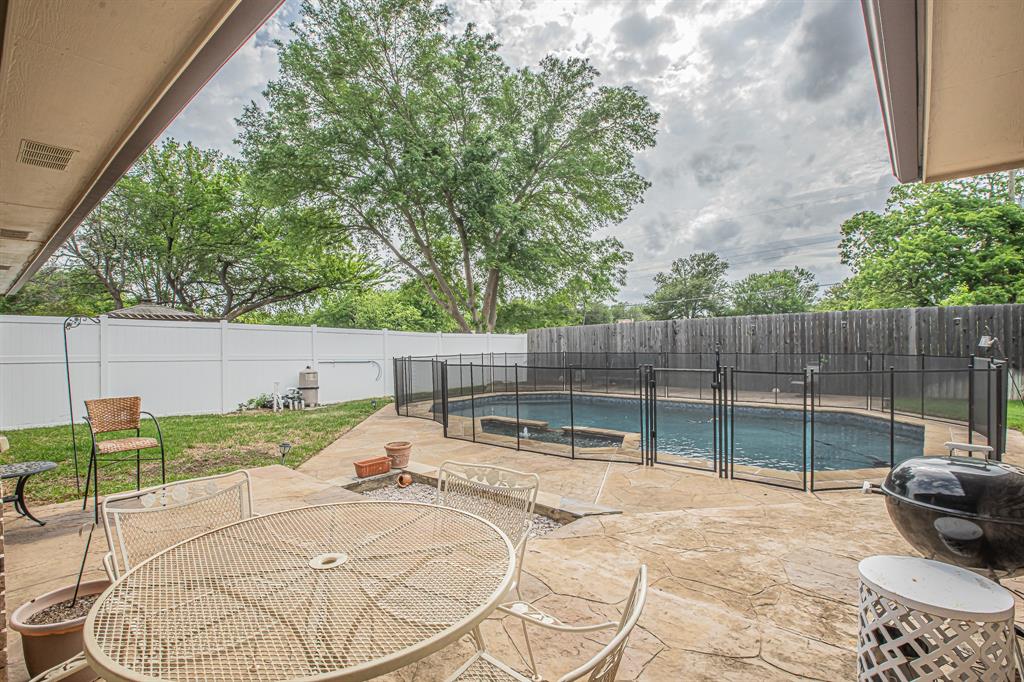 3309 Timber View Circle Bedford, TX 76021 - Photo 38 of 38 a view of backyard with white house and outdoor seating