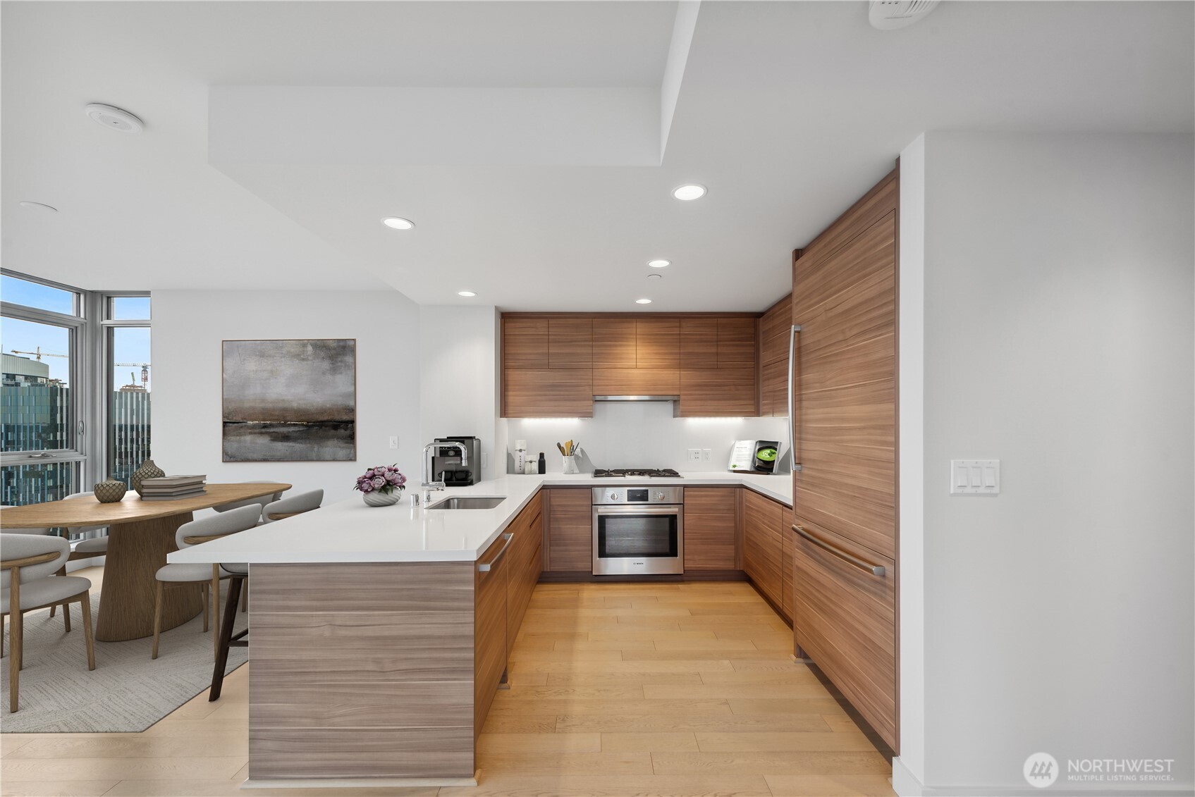 583 Battery Street, Unit 3103N Seattle, WA 98121 - Photo 3 of 39 a large white kitchen with a large window and stainless steel appliances