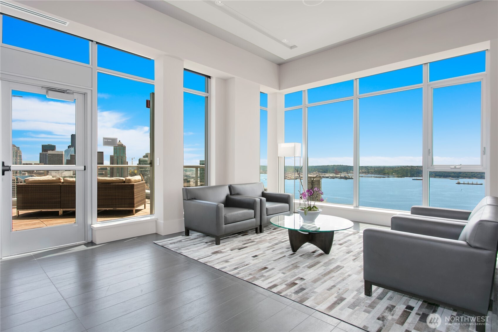 583 Battery Street, Unit 3103N Seattle, WA 98121 - Photo 32 of 39 a living room with furniture and a floor to ceiling window