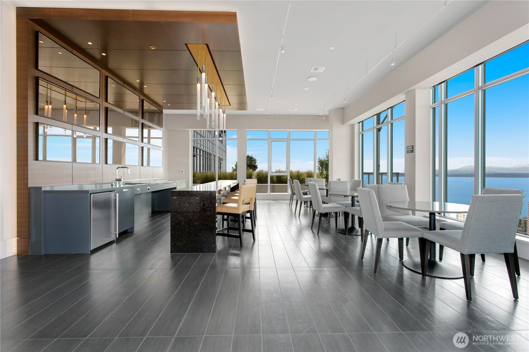 583 Battery Street, Unit 3103N Seattle, WA 98121 - Photo 33 of 39 a living room with lots of furniture wooden floor and a large window