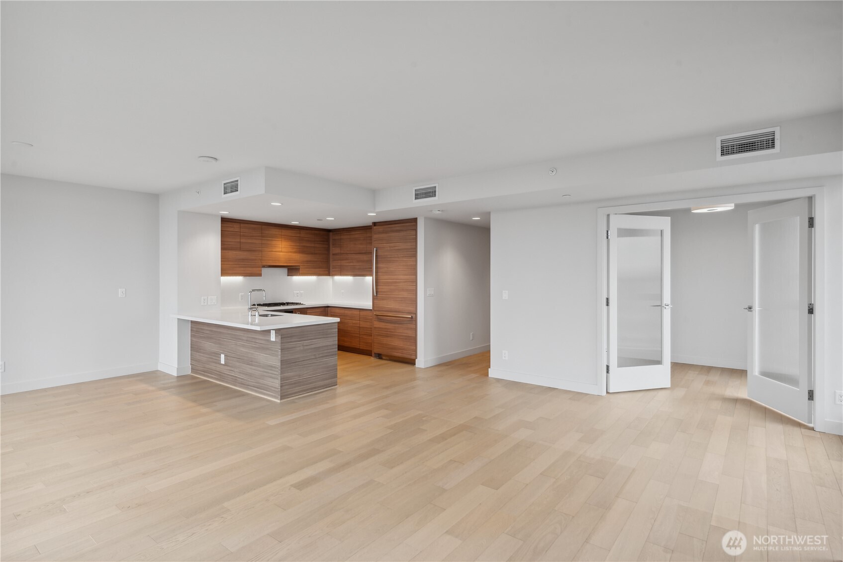 583 Battery Street, Unit 3103N Seattle, WA 98121 - Photo 10 of 39 a kitchen with stainless steel appliances kitchen island granite countertop a refrigerator and a stove