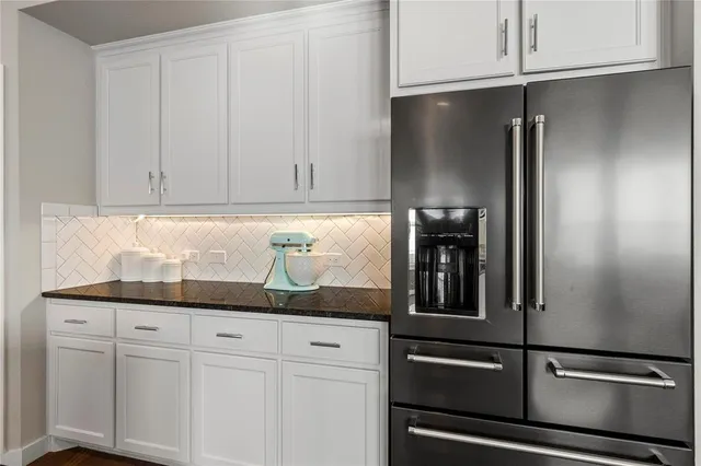 a kitchen with granite countertop cabinets and stainless steel appliances