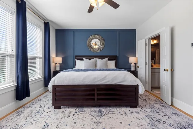 a bed sitting in a bedroom next to a window