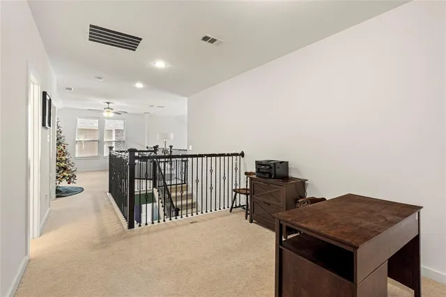 a view of a hallway to a room with stair