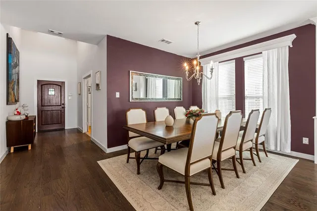 a view of a a dining room with furniture window and wooden floor