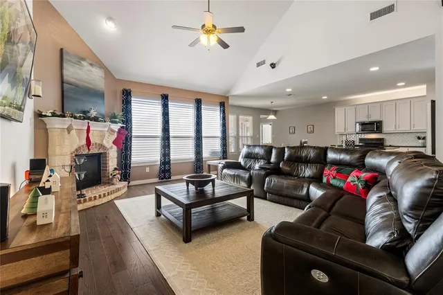 a living room with furniture a flat screen tv and a large window