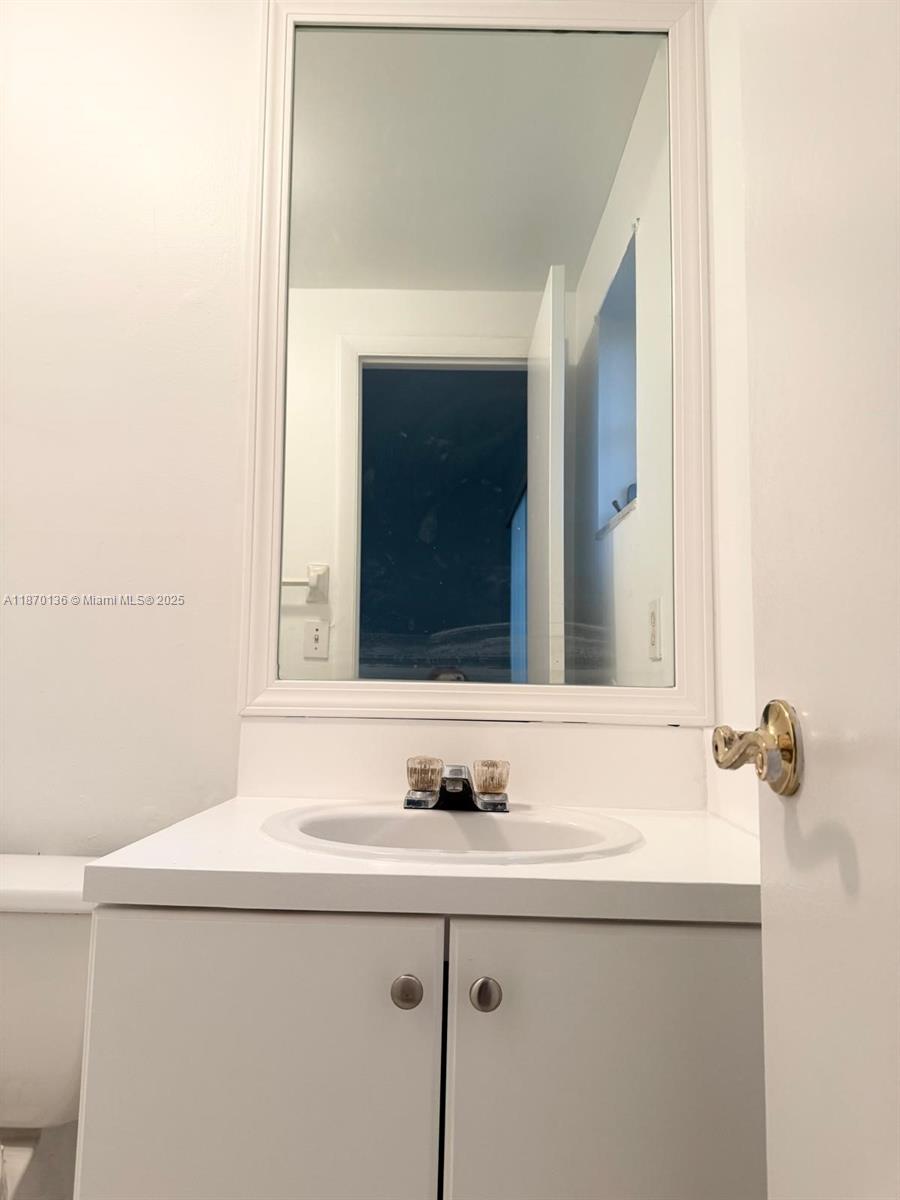8500 Southwest 109th Avenue, Unit 6118 Miami, FL 33173 - Photo 14 of 15 a bathroom with a sink and a mirror