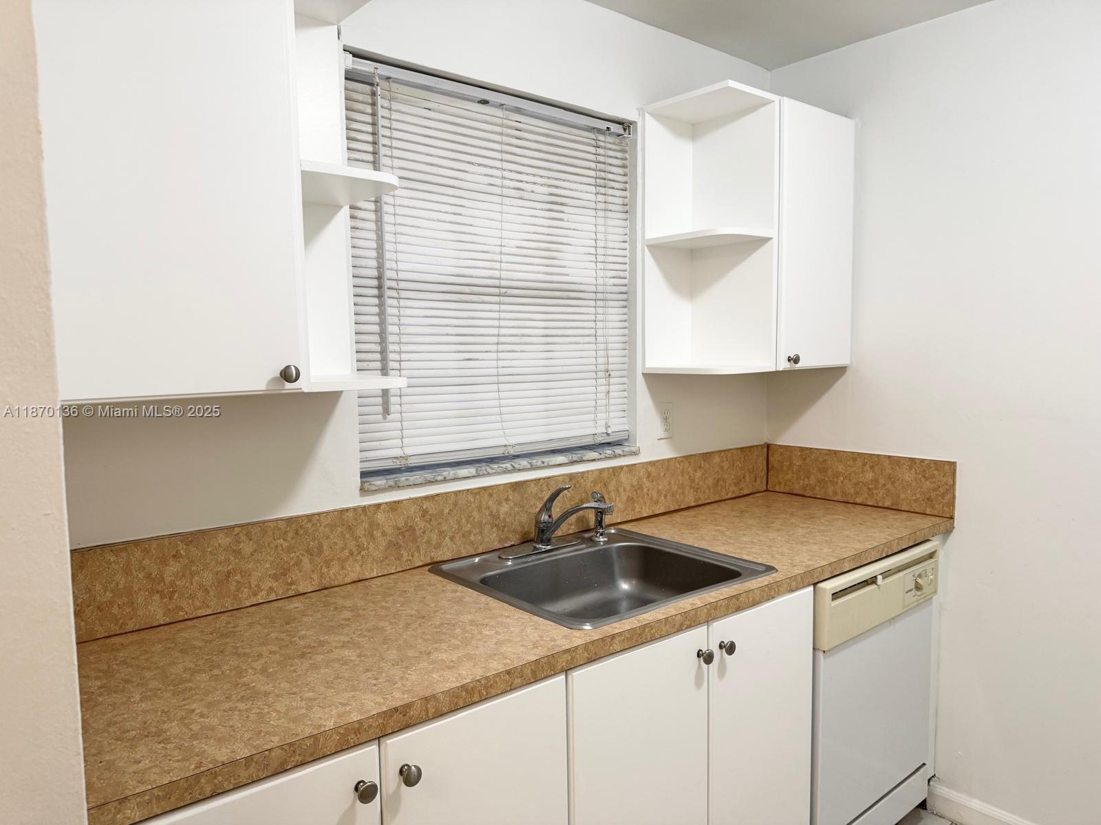 8500 Southwest 109th Avenue, Unit 6118 Miami, FL 33173 - Photo 2 of 15 a kitchen with a sink cabinets and a window