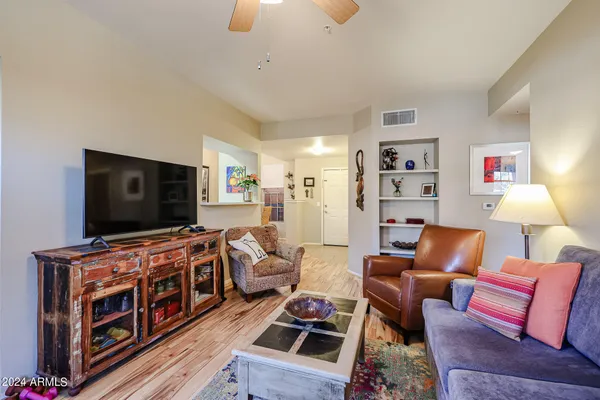 a living room with furniture and a flat screen tv