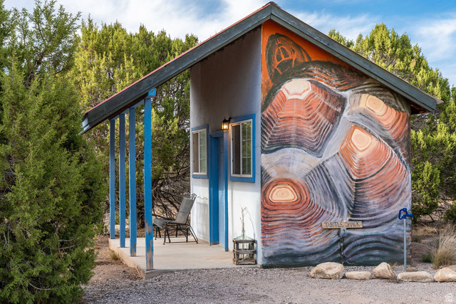 11550 Pigeon Hollow Road Spring City, UT 84662 - Photo 57 of 85 Shed structure with a distinct wall mural, covered porch with support pillars, and exterior lighting